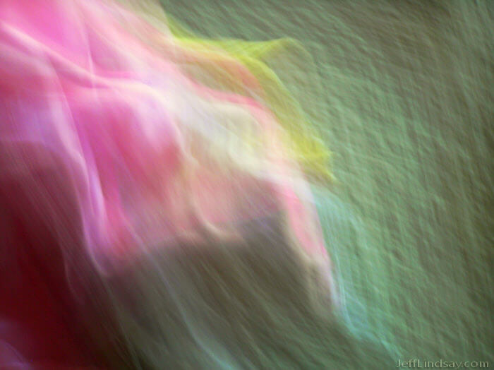 Abstract formed by photographing my niece in pink with a yellow bunny while moving an Olympus C-725 camera rapidly.