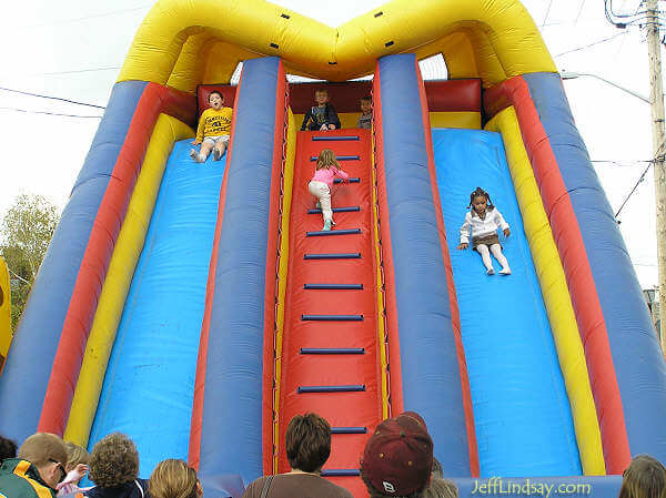 Kids enjoy an inflatable slide.