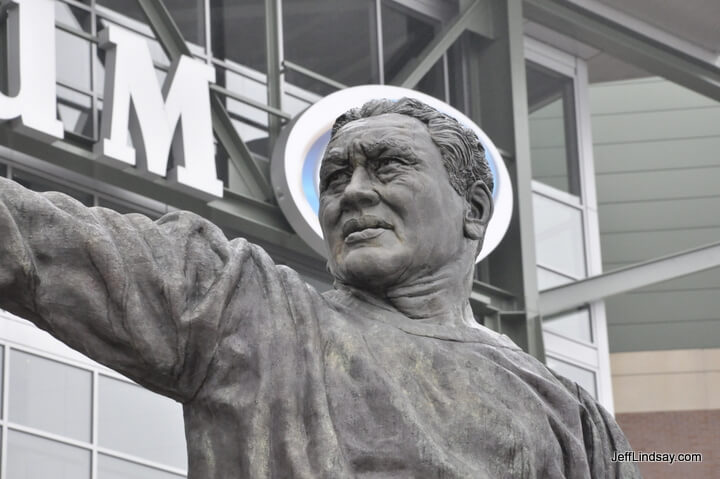 Saint Curly Lambeau, one of football's pattron saints, is honored with this statue in front of Lambeua Field. The halo is couresy of Miller Beer and their oval sign on the stadium itself.