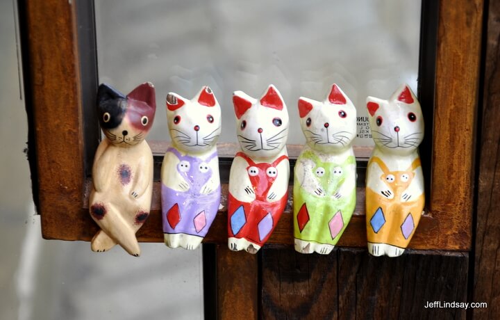 Little kitten figurines on a ledge on a wooden door in Seoul, Korea, October 2011.