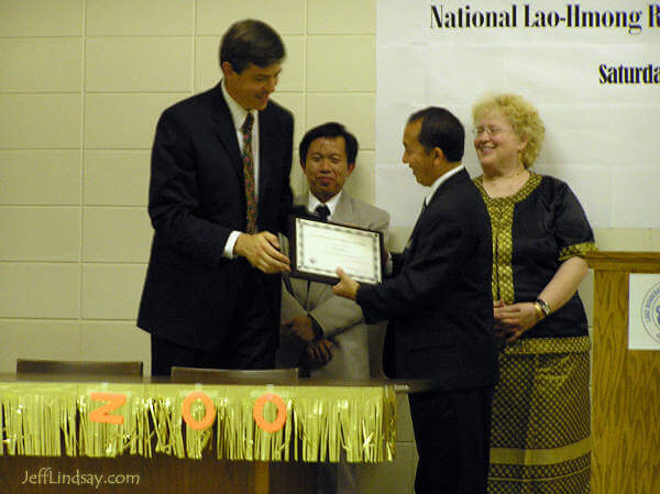 Jeff Lindsay receiving a plaque after his hour-long presentation at the National Lao-Hmong Recognition Day event.