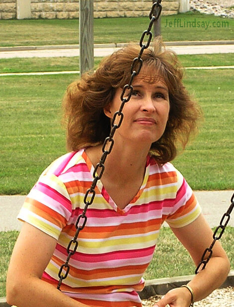 Candid photo, used with permission, of a beautiful woman swinging at Menominee Park in Oshkosh.