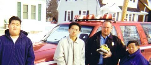 Peter Lee, Hue B. Lee, and Lee Pao Vang with Jim Peglow in Menasha
