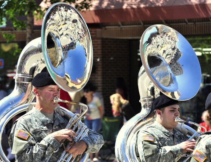 Dual tubas from a military marching band at the Appleton Flag Day Parade, June 13, 2009. I like the reflections of the town captured in the bells of these brass instruments.