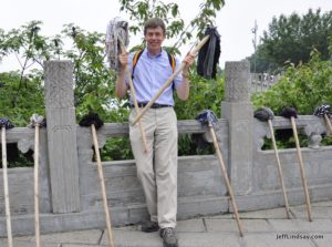 Jeff Lindsay holding two mops