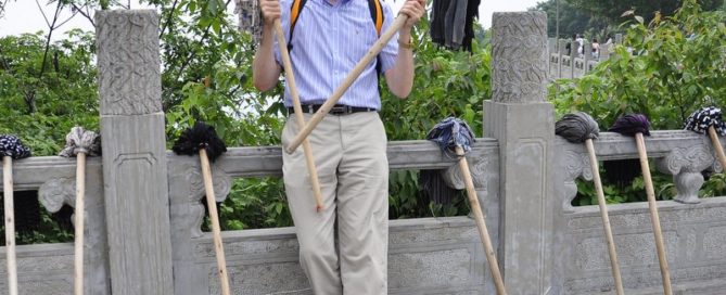 Jeff Lindsay holding two mops