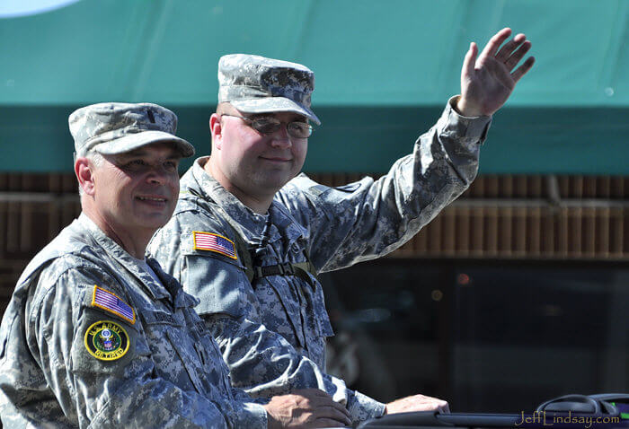 Two soldiers waving to the crowd at the Flag Day Parade, May 2009.