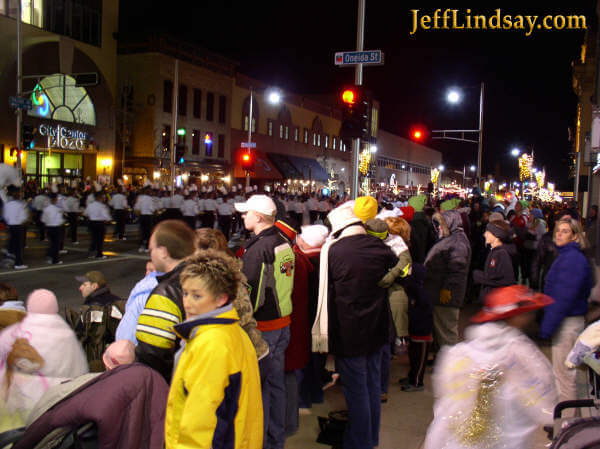 Thousands of people line the streets to watch the Christmas parade.