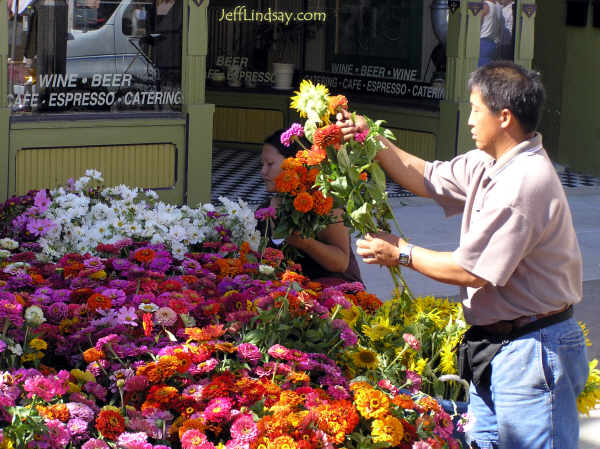 A Hmong man prepares bouquets of flowers at the farmers' market, Aug. 6, 2005.