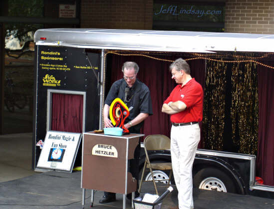 Bruce Hetzler shows Mayor Timothy Hanna a new hands-on way to cut taxes - or other objects.