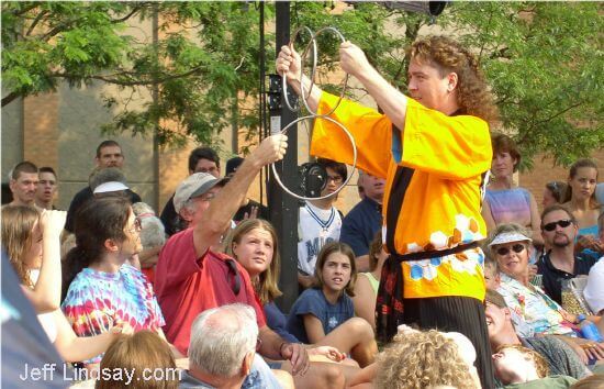 Jeff McBride performs the Chinese Linking Rings for an outdoor audience near Houdini Plaza.