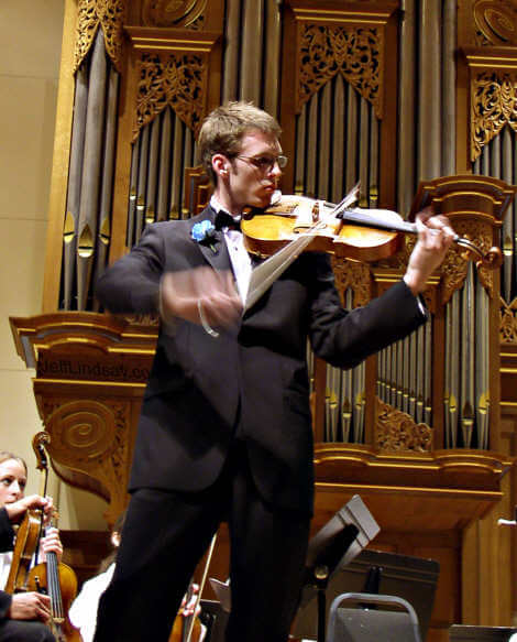 Jon Kiefer, a senior at North High School, performs a viola solo at the 31st Annual Commencement Concert. He played Johann Stamitz's Viola Concerto in D Major, first movement.