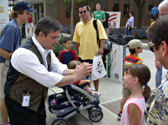 Magician Lou Lepore amazes a child with some sleight of hand.