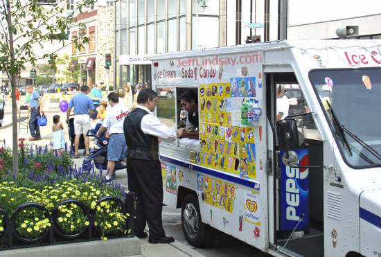 Magician Lou Lepore of Menasha refreshes at a colorful vending cart on College Avenue.