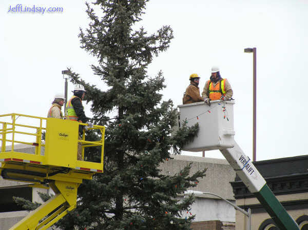 Workers remove Christmas lights from a tree at Houdini Plaza in downtown Appleton, Jan. 5, 2006.