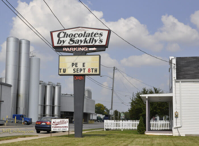 Signs on Neenah stores sometimes puzzle outsiders. Here Neenah's famous chocolate shop, Sayklly's, reminds Neenah residents of an important health practice--one that should be done everyday, in my opinion, not just on Sept. 8. 
