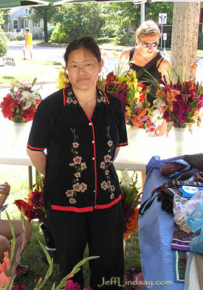 A Hmong woman selling flowers.