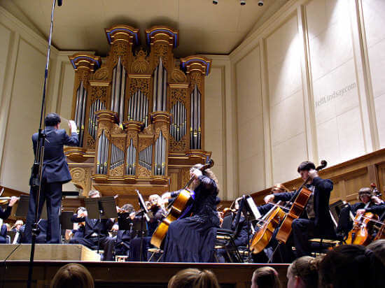 Gary Wolfman conducts the Fox Valley Youth Symphony before the backdrop of the impressive organ in the Lawrence Chapel.