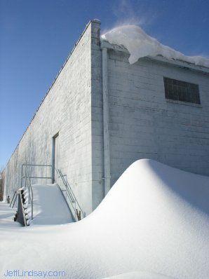 Snow drift accumulating behind a building in Neenah, Feb. 2004.