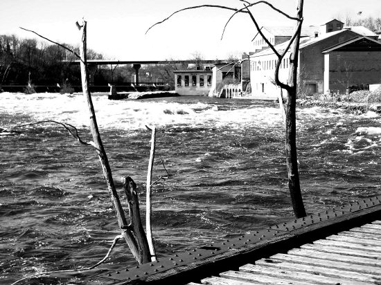 Black and white photo taken from a railroad bridge over the Fox River in 2004, before I found the sign at one end only telling people to stay off the bridge.