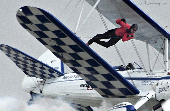 A stuntman prepares to stand on top of an airplane for a skywalking demonstration at the EAA Convention in Oshkosh, July 2009.