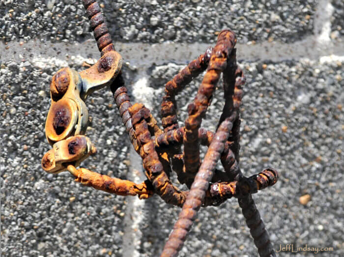 Rusty rebar protruding from a wall on a building in secluded alley in downtown Appleton, Wisconsin.