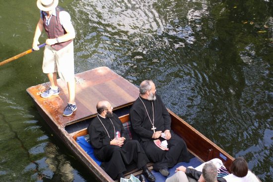 Two Orthodox priests touring the Cam River in a punt.