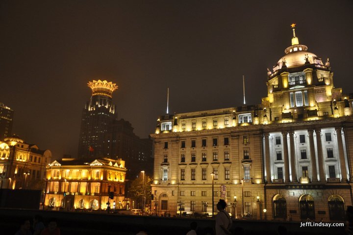 The Bund Center with its crown rises from Bund at night. It's there in the day, too.