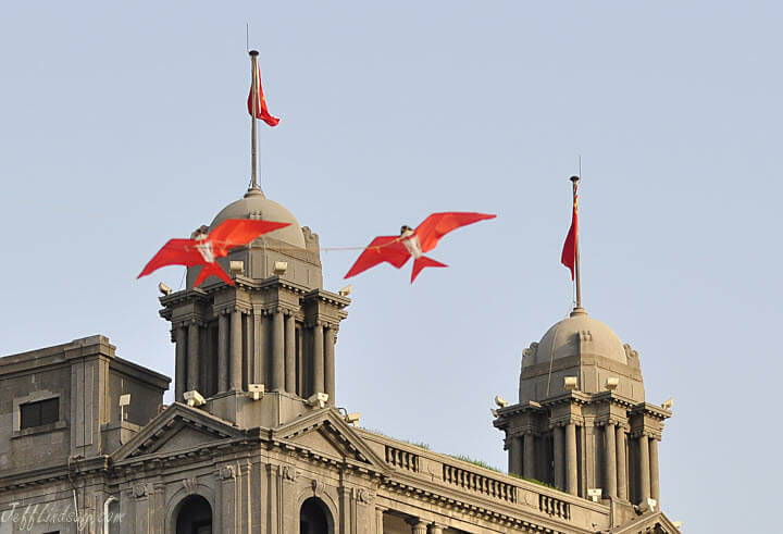 An interesting kite with two birds connected by a spring fly in front of the Bund, May 2011.