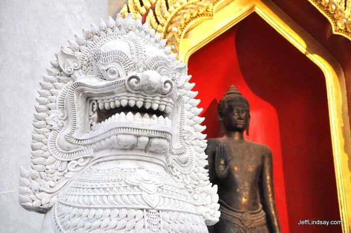 Lion statue in front of a temple at a major palace in Bangkok.