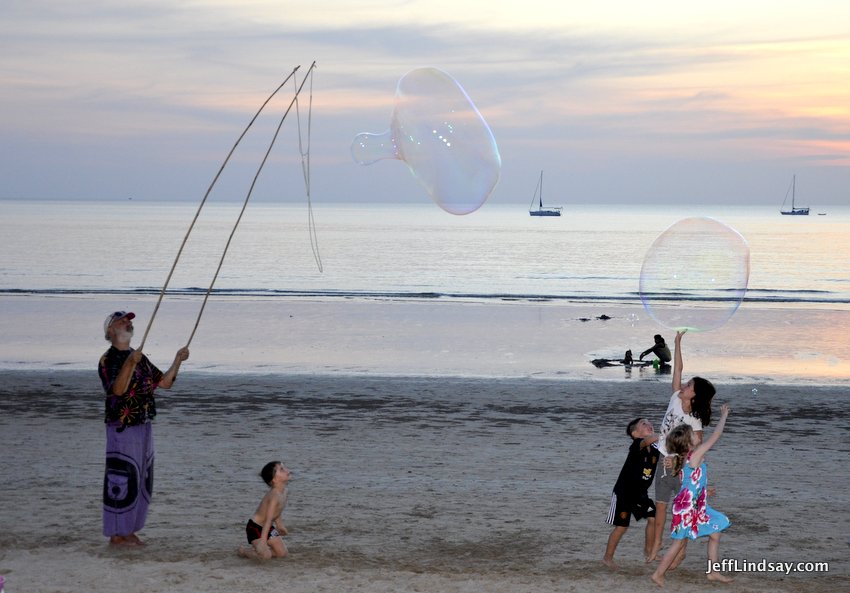 >A young girl experiences the magical moment when you touch a giant bubble and discover it's still there. Lanta Island, Jan. 2017.