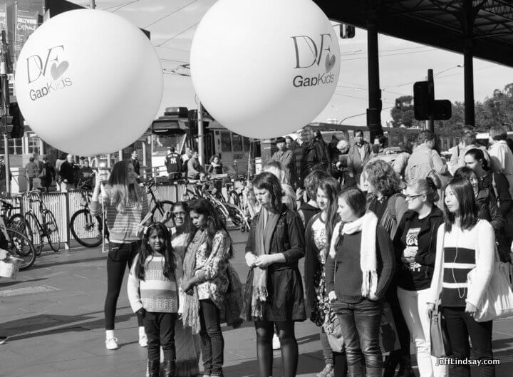 Pedestrians in front of Flinders Station, black and white. Melbourne, Australia, May 2013