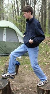 Ben navigating some logs at a father and sons camp, May 16, 2003