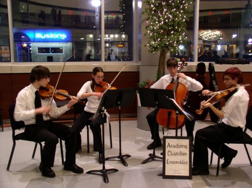 Benjamin playing cello in a quartet, performing in the lobby of the Performing Arts Center (PAC) on Feb. 21, 2004.