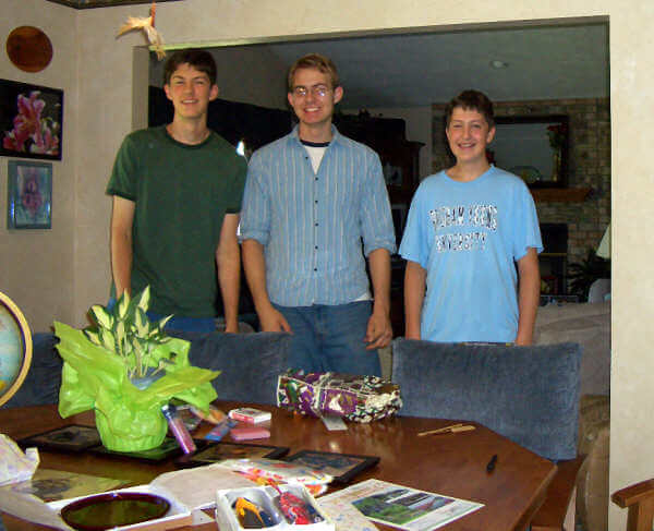Three Lindsay boys, Daniel, Mark, and Ben, in front of some gifts from Japan brought to us by Keiko Onishi. July 2005. Photo courtesy of Keiko.