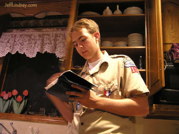 Daniel reading right after finishing some work as an assistant leader for a Cub Scout program.