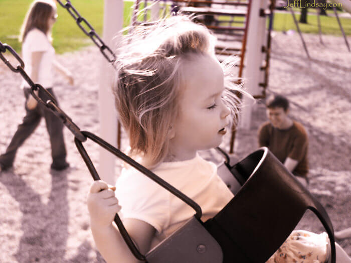 Anna swinging in Madison, Wiscosnin, April 2008. Her parents, Stephen and Meliah, are in the background.