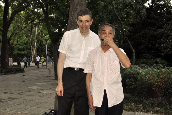 Jeff next to a new friend, a gifted harmonica player at Zhongshan Park in Shanghai, July 7, 2011. I was slouching to decrease the height difference for the photo, making me look thinner than I really was, though I had lost some weight during my early days in China when I was often too busy to eat enough.