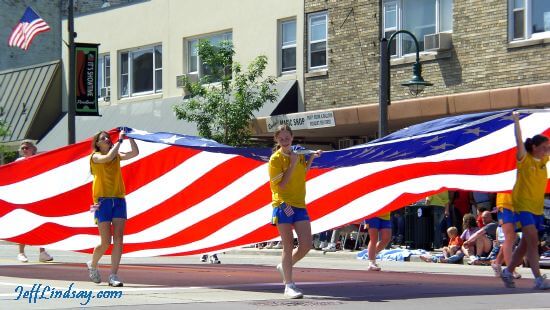 Girls carrying the United States Flag