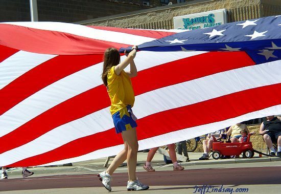 Girls carrying the United States Flag