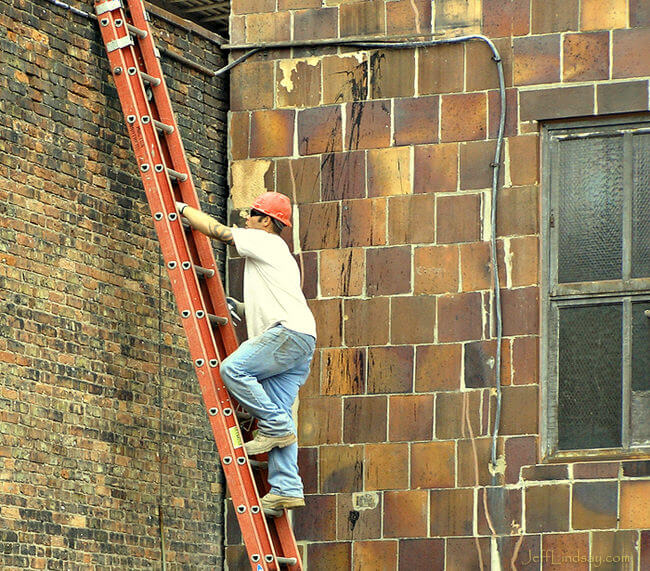 Man climbing a ladder in downtown Milwaukee, Aug. 2008.