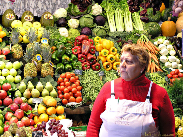 Another woman ruling over her domain of produce at the market.