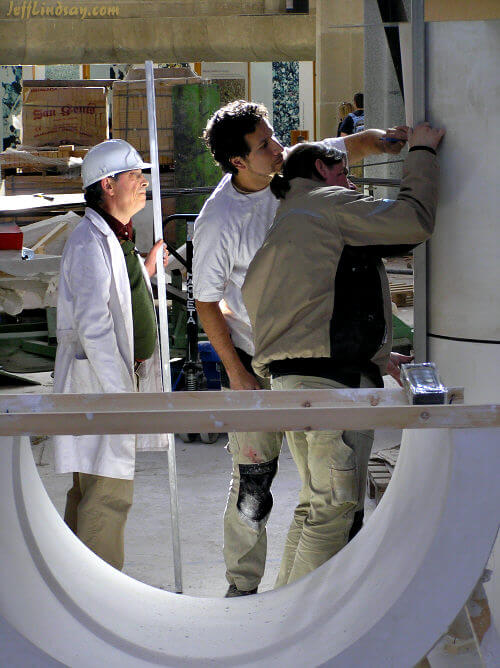 Workers puzzling over a complex column while building the amazing monument of Antoni Gaudi, the Sagrada Familia church in Barcelona..