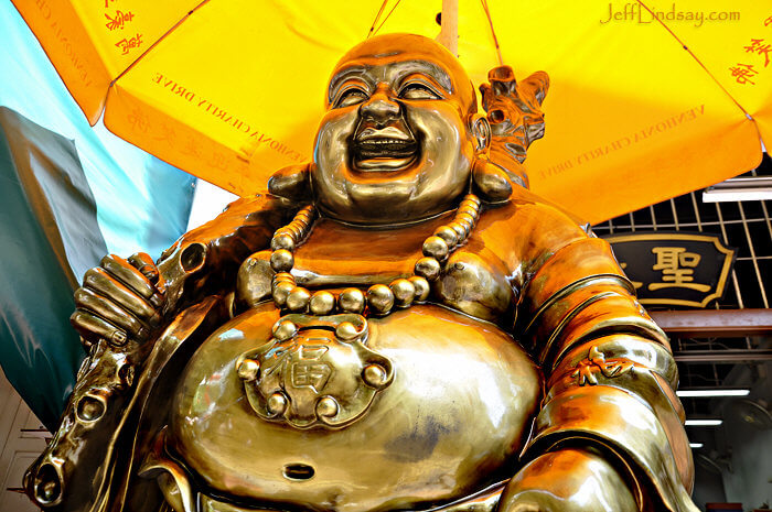 A happy Buddha statue in front of a shop in Chinatown in Singapore.